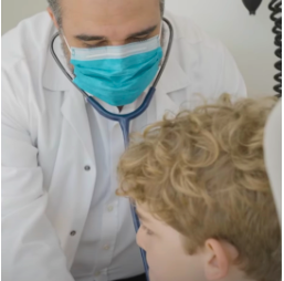 Stem cell doctor talking to a boy about stem cell treatment